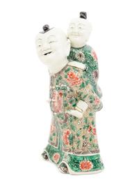 A Chinese Famille Verte Biscuit Porcelain 'Piggyback' Group