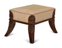 An Egyptian Revival Carved Mahogany Ottoman with Upholstered Seat — 20th Century