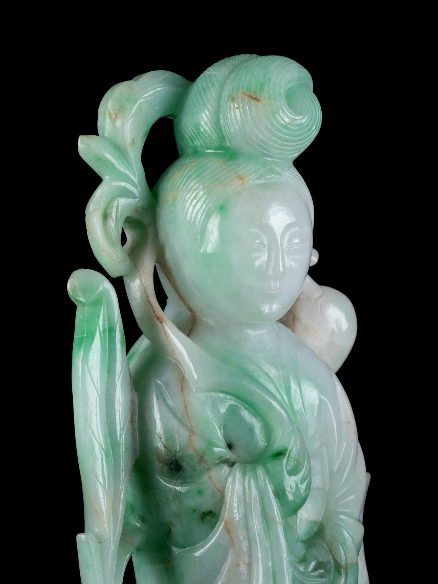 A Chinese Apple Green and Pale Celadon Jadeite Figure of Guanyin