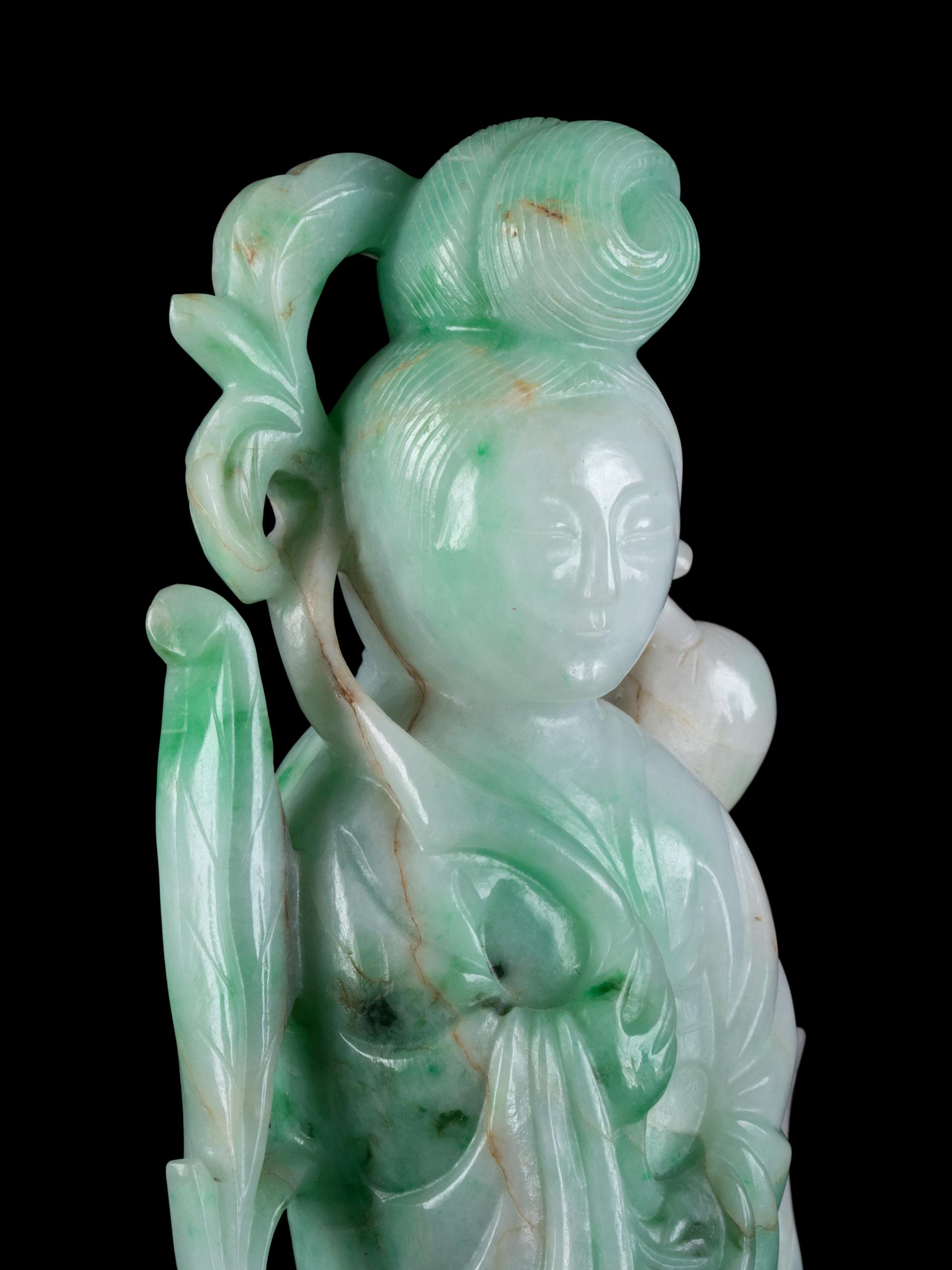 A Chinese Apple Green and Pale Celadon Jadeite Figure of Guanyin