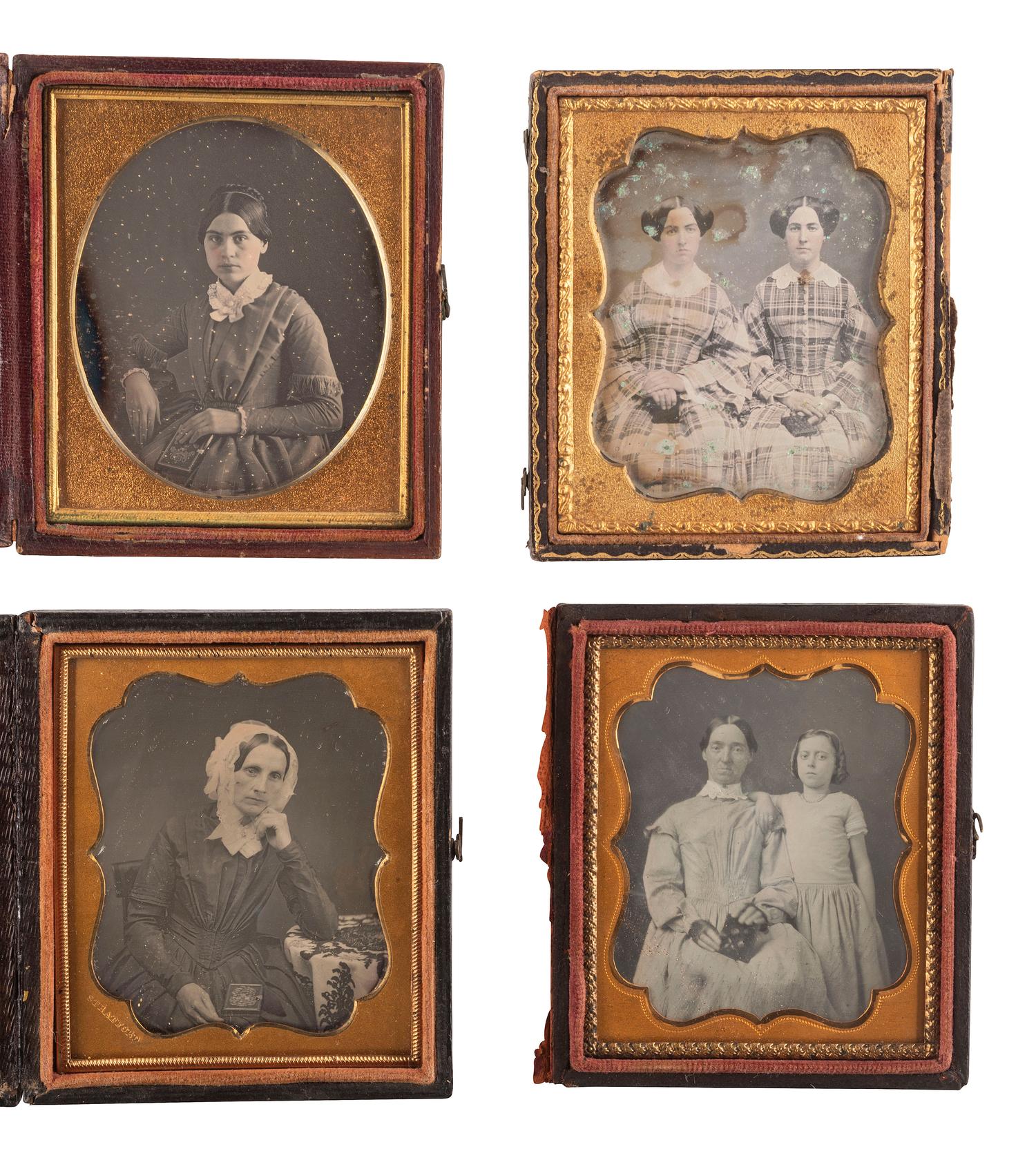 [EARLY PHOTOGRAPHY]. A group of 23 daguerreotypes featuring subjects posed with cased images, including: