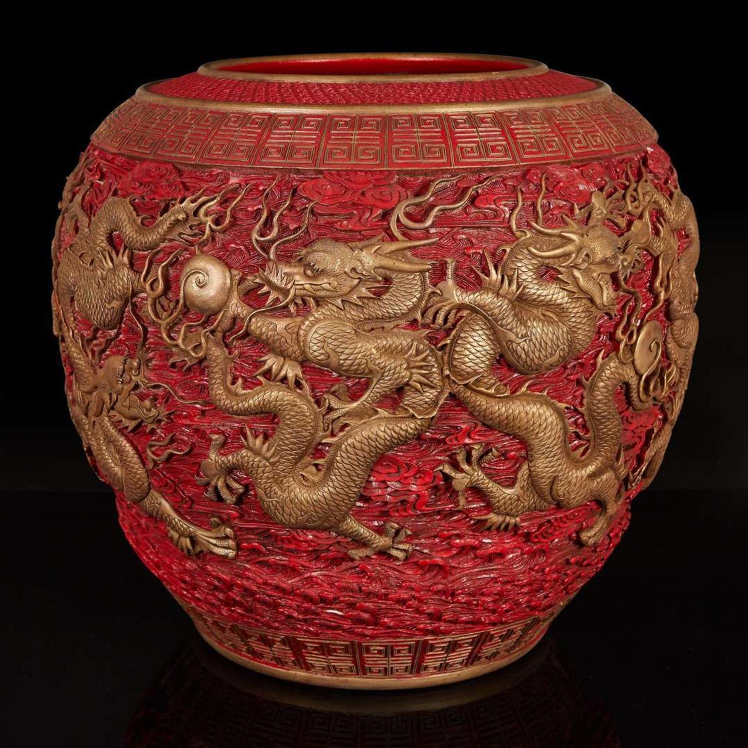 A massive Chinese faux cinnabar lacquer modeled porcelain "Dragons" jardinière 朱紅漆繪模印龍紋缸 Qianlong six character mark in relief to the neck ?????