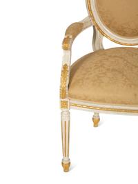 A Set of Eight Louis XVI Style Painted and Parcel Gilt Fauteuils