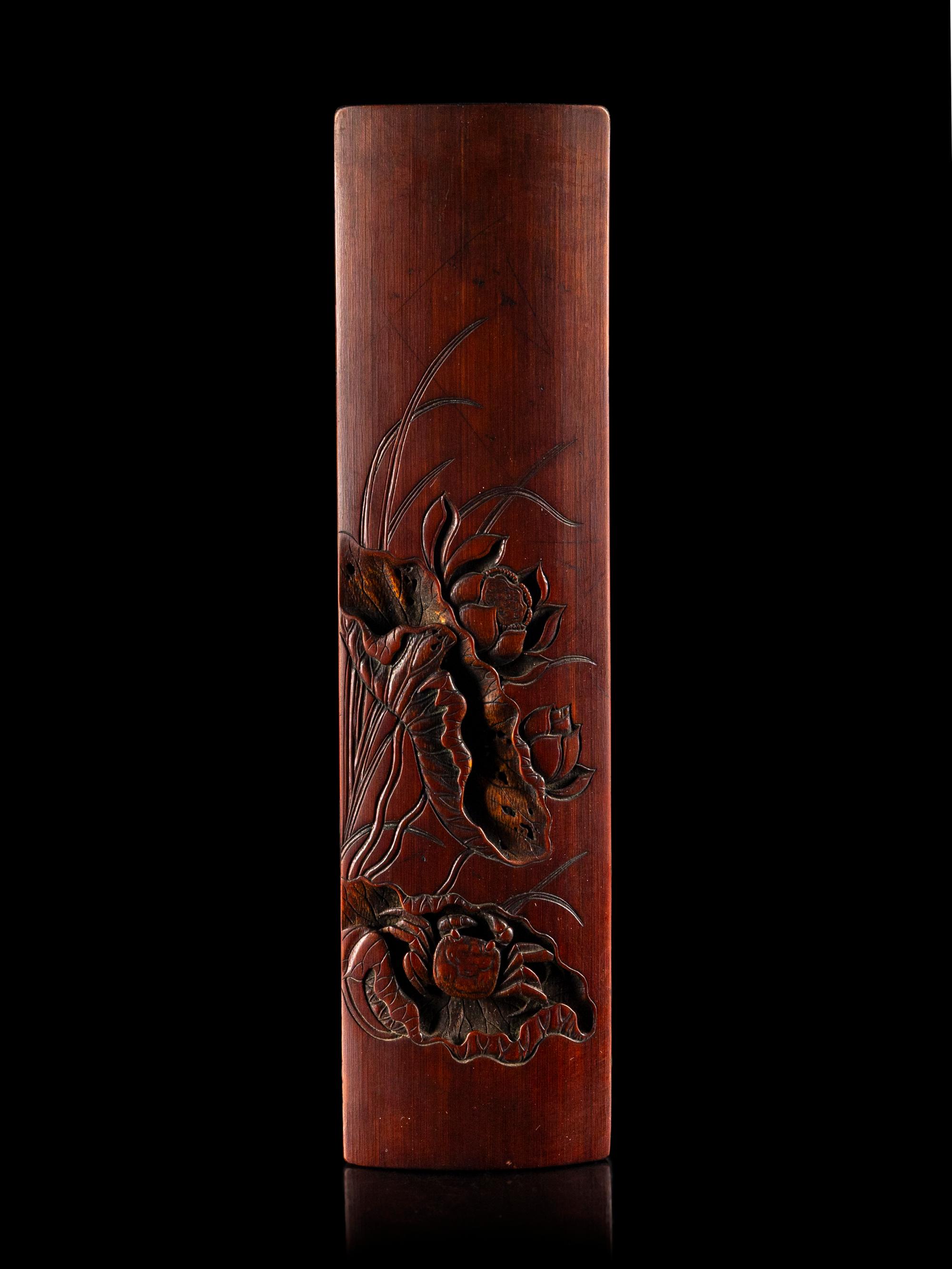 A Chinese Carved Bamboo 'Lotus and Crab' Wrist Rest