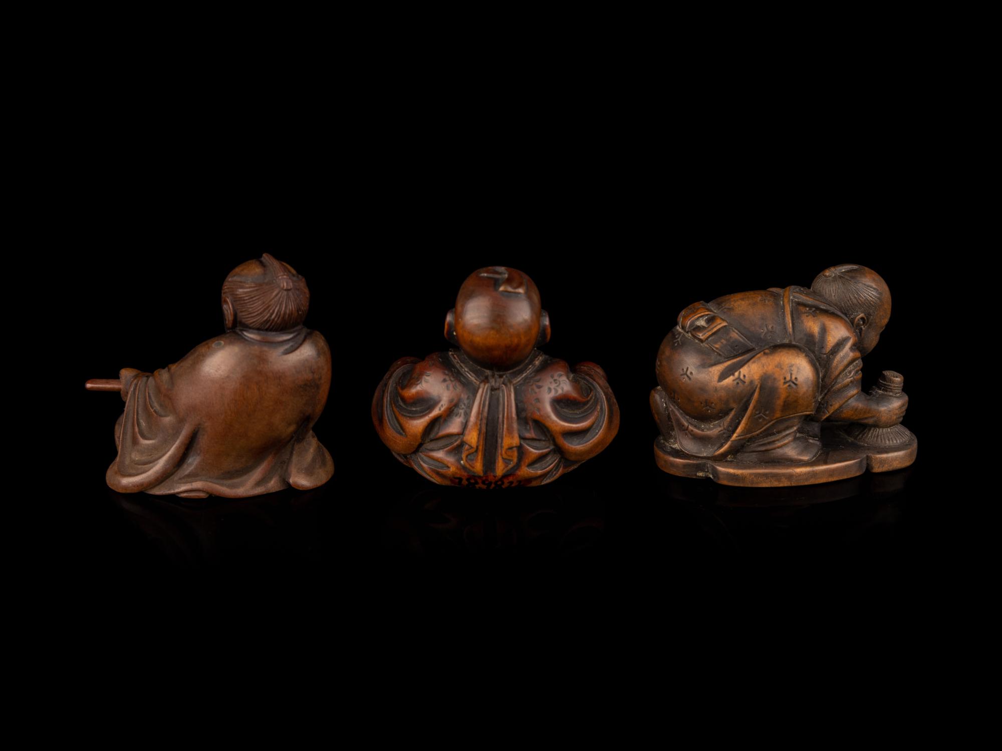 Three Japanese Carved Boxwood Figural-Form Netsuke