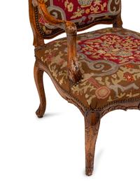 A Pair of Régence Walnut Needlepoint-Upholstered Fauteuils