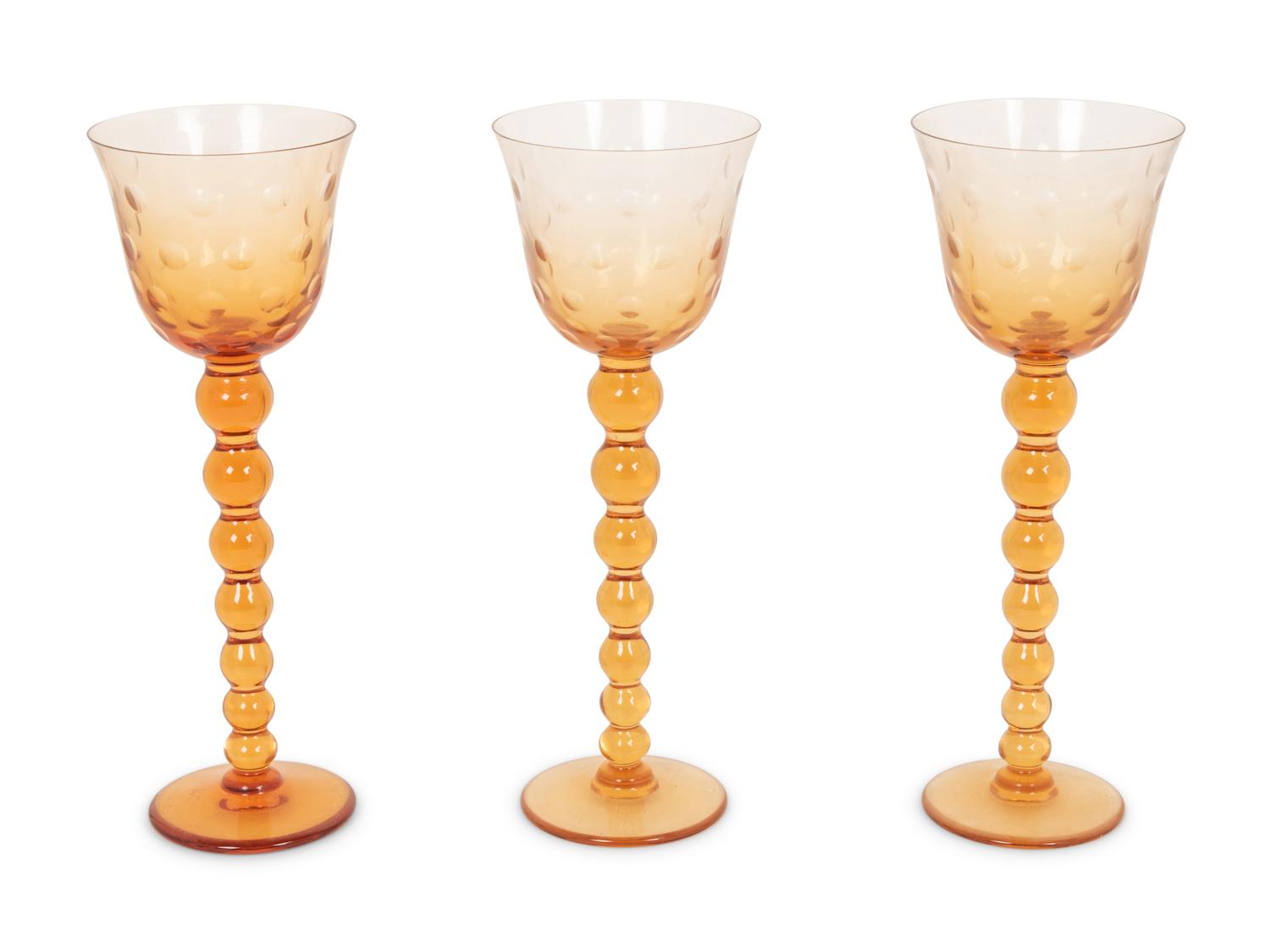 A Set of Fifteen St. Louis Amber Glass Stems