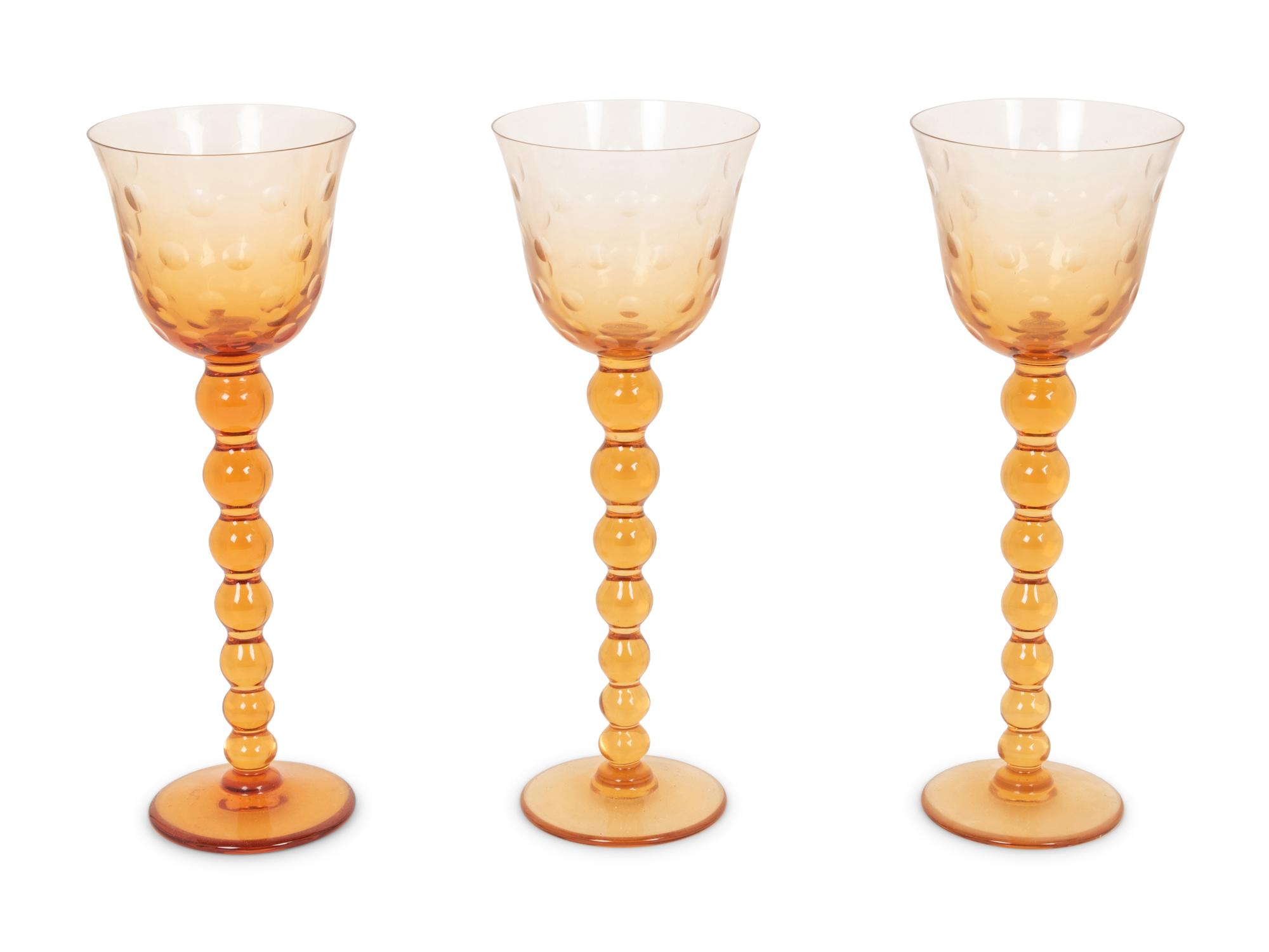 A Set of Fifteen St. Louis Amber Glass Stems