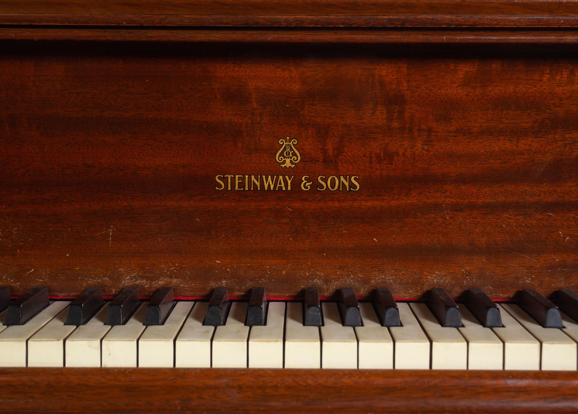 A Steinway and Sons Walnut Grand Piano and Bench