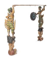 A Pair of Southeast Asian Carved and Polychrome Decorated Figures with a Gong