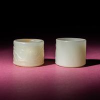 Two Chinese White Jade 'Animal' Archer's Rings, 18th Century — 清中期 白玉刻動物紋扳指兩枚