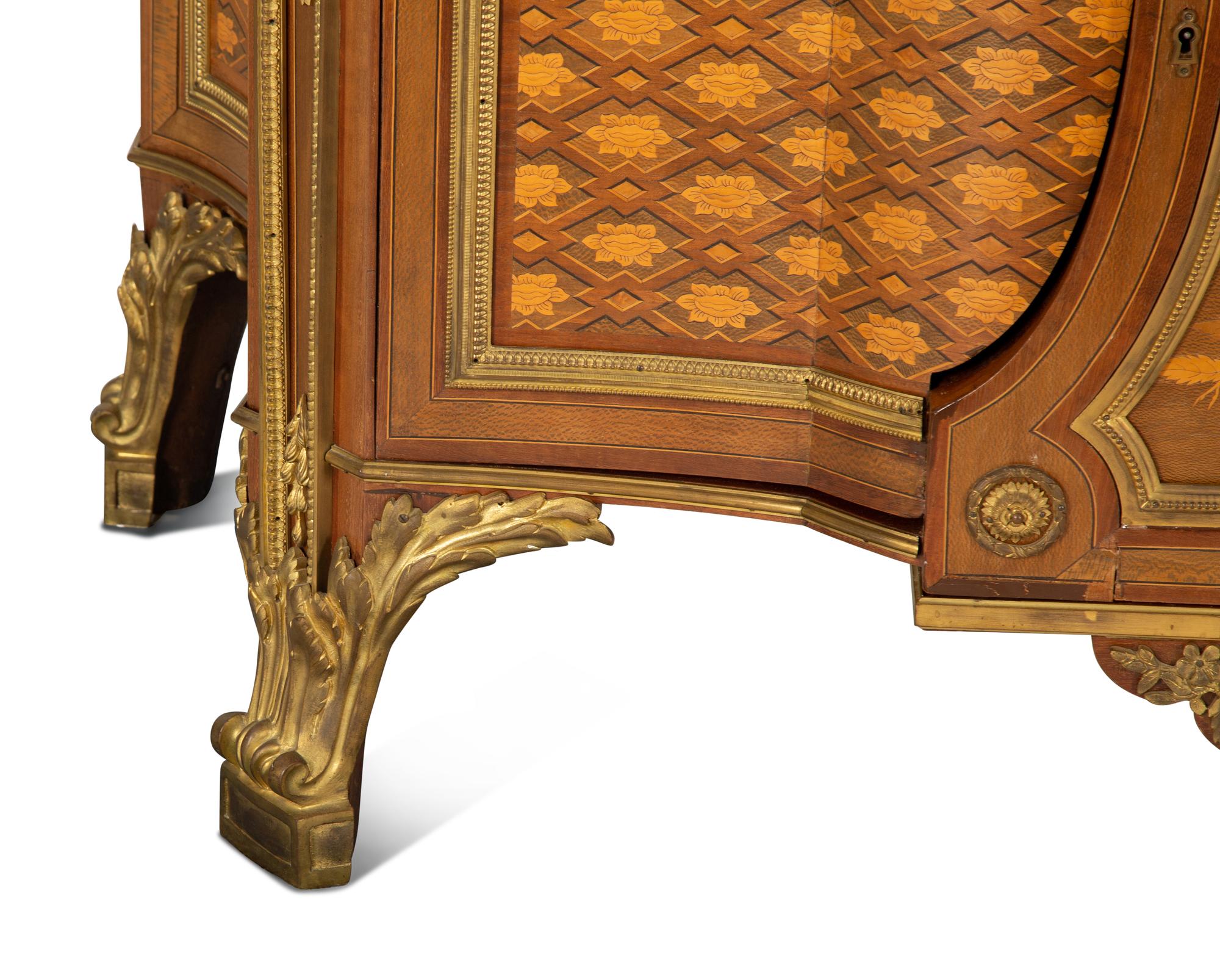 A Louis XVI Style Gilt Bronze Mounted Kingwood and Marquetry Marble-Top Commode