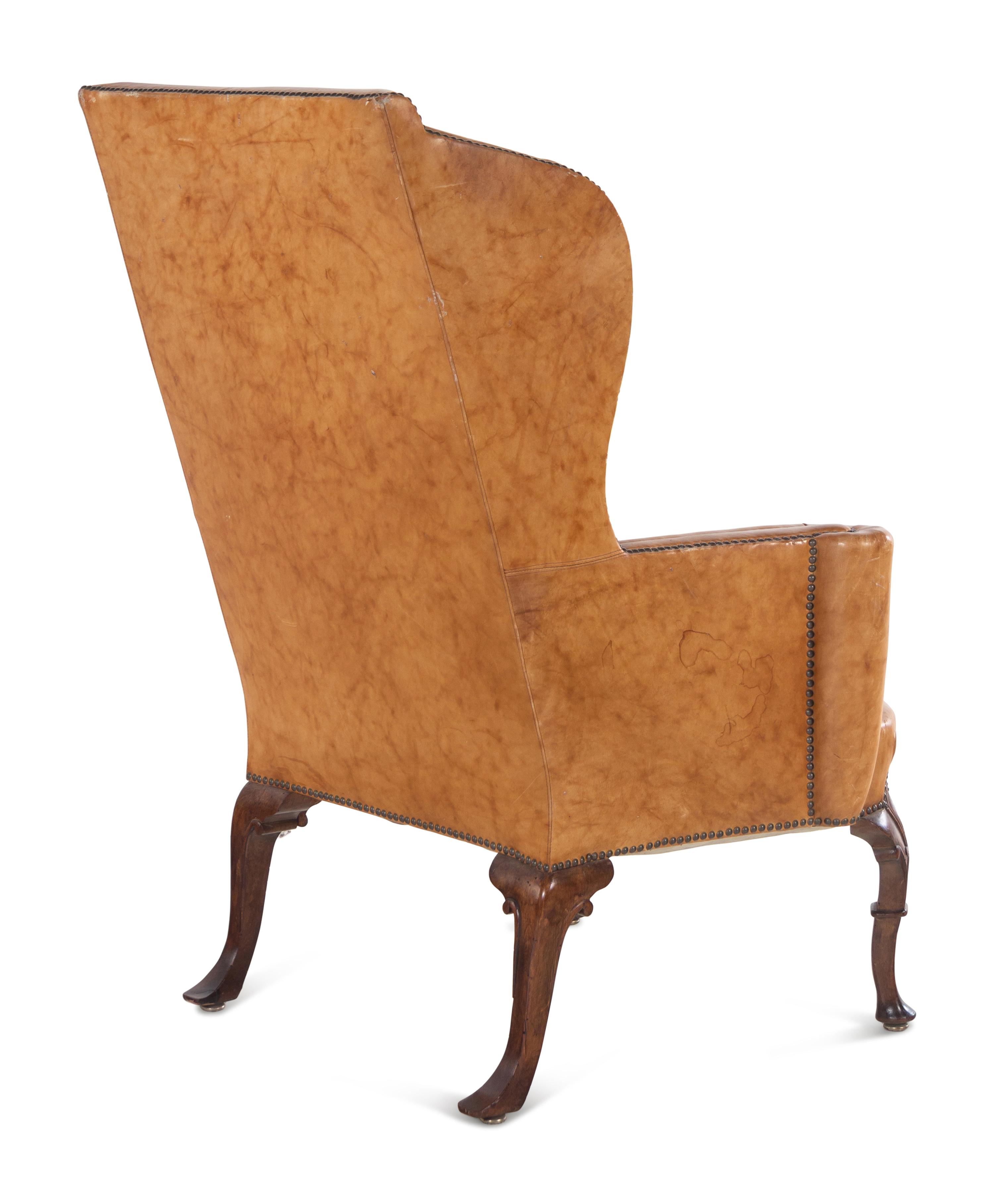 A Georgian Style Faux Leather Upholstered Walnut Wing Chair