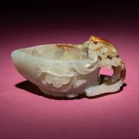 A Chinese Russet and Celadon Jade ‘Magpie and Plum Blossoms’ Peach-Form Coupe, 19th Century — 清晚期 青白玉帶皮喜上眉梢桃形杯