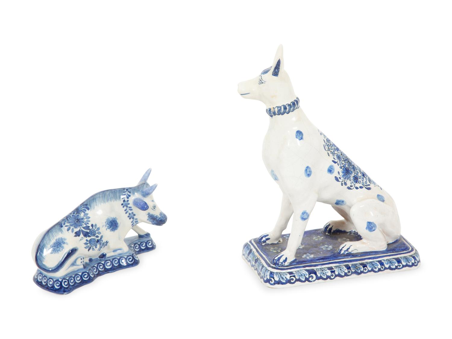 A Delft Blue and White Seated Dog and a Recumbent Cow