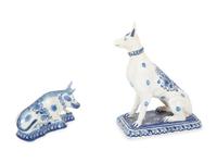 A Delft Blue and White Seated Dog and a Recumbent Cow