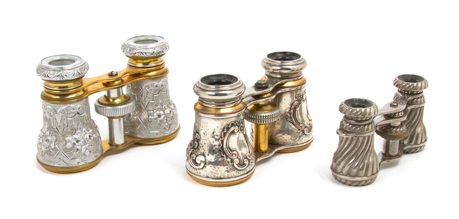 Three Pairs of Continental Silver or Silvered Metal Mounted Opera Glasses, Width of widest 4 1/4 inches.