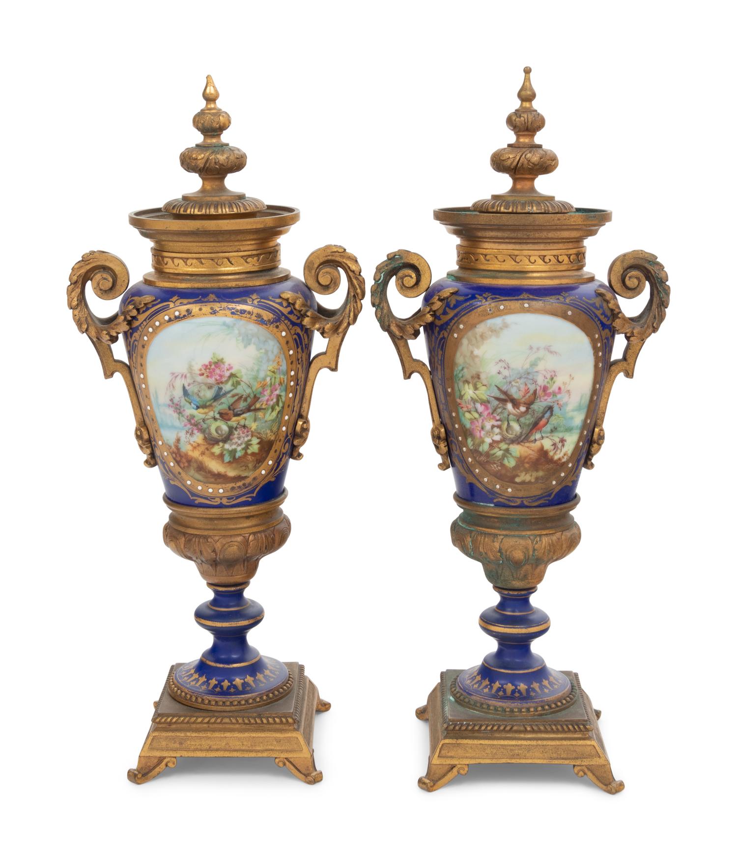 A Pair of Sèvres Style Gilt Bronze Mounted Porcelain Urns