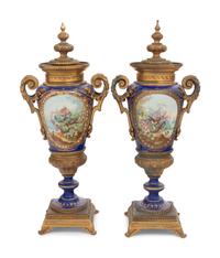 A Pair of Sèvres Style Gilt Bronze Mounted Porcelain Urns