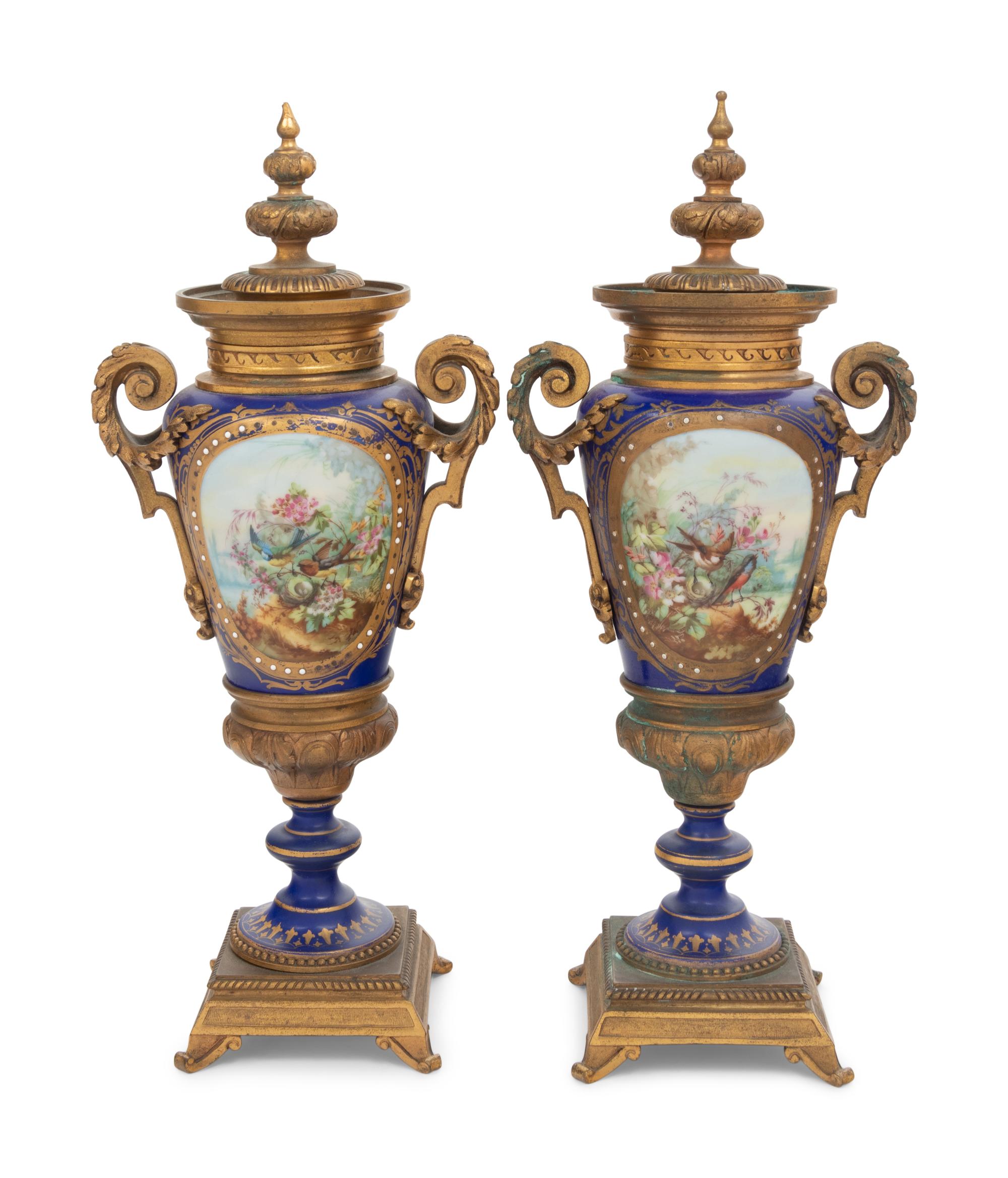 A Pair of Sèvres Style Gilt Bronze Mounted Porcelain Urns