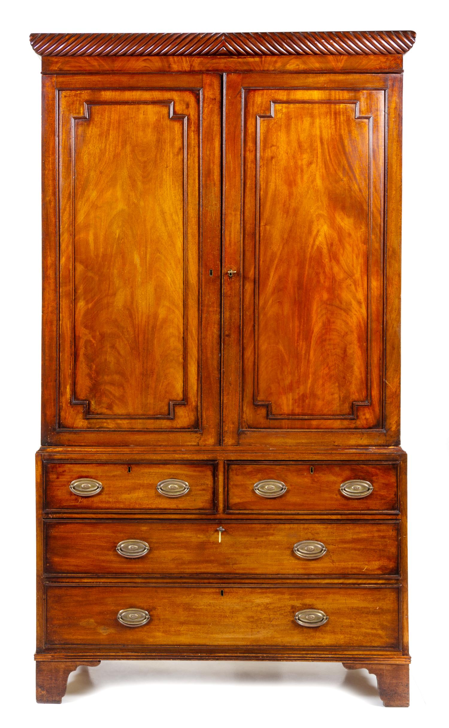 A George III Mahogany Linen Press Height 86 1/2 x width 47 3/4 x depth 20 3/8 inches. — EARLY 19TH CENTURY, THE CORNICE LATER