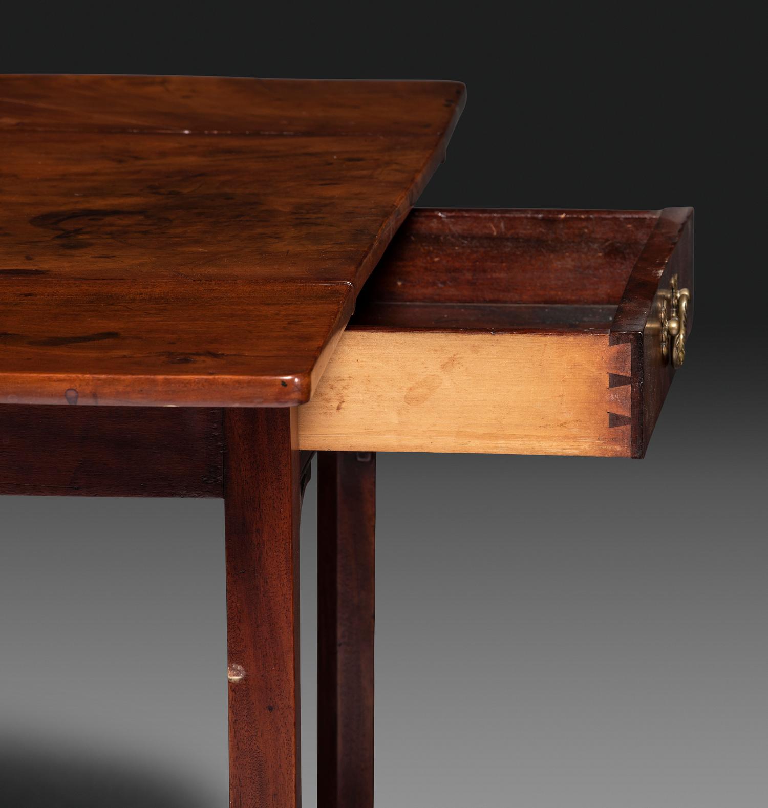 A Late Chippendale Carved and Figured Mahogany Stretcher-Base Pembroke Table