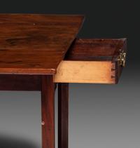A Late Chippendale Carved and Figured Mahogany Stretcher-Base Pembroke Table