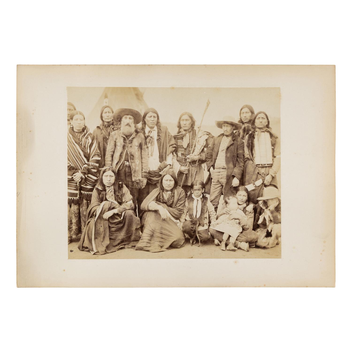 [Native Americana]. Albumen photograph of Indian Scout John Nelson posed with Plains Indians.