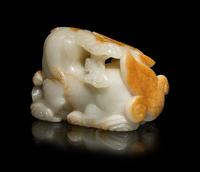 A Chinese Russet and White Jade Carving of a Mythical Beast