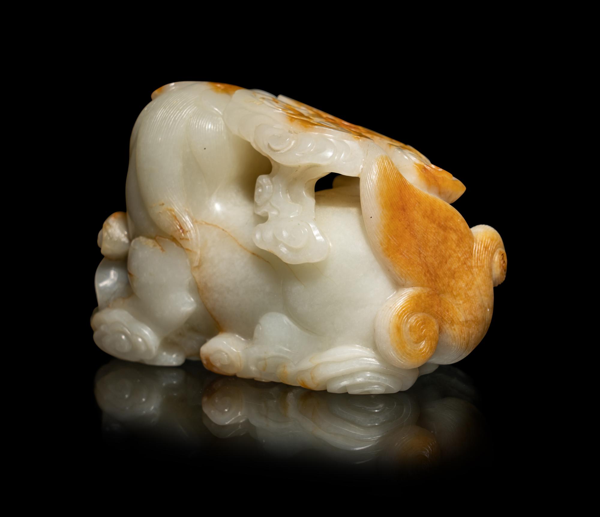 A Chinese Russet and White Jade Carving of a Mythical Beast