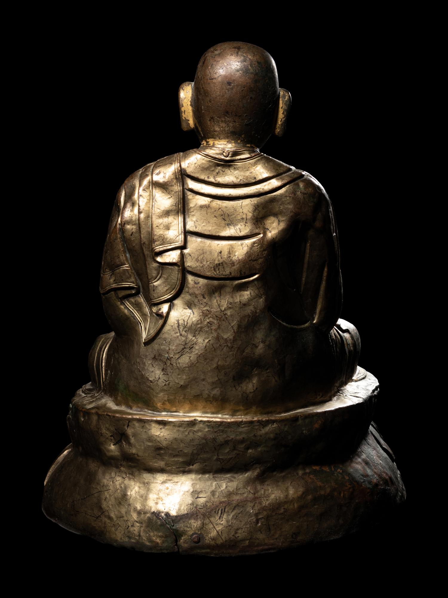 A Large Tibetan Parcel Gilt Bronze Repoussé Figure of a Seated Monk