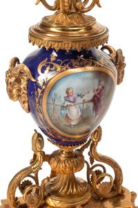 A Louis XVI Style Gilt Bronze and Sèvres Style Porcelain Clock Garniture