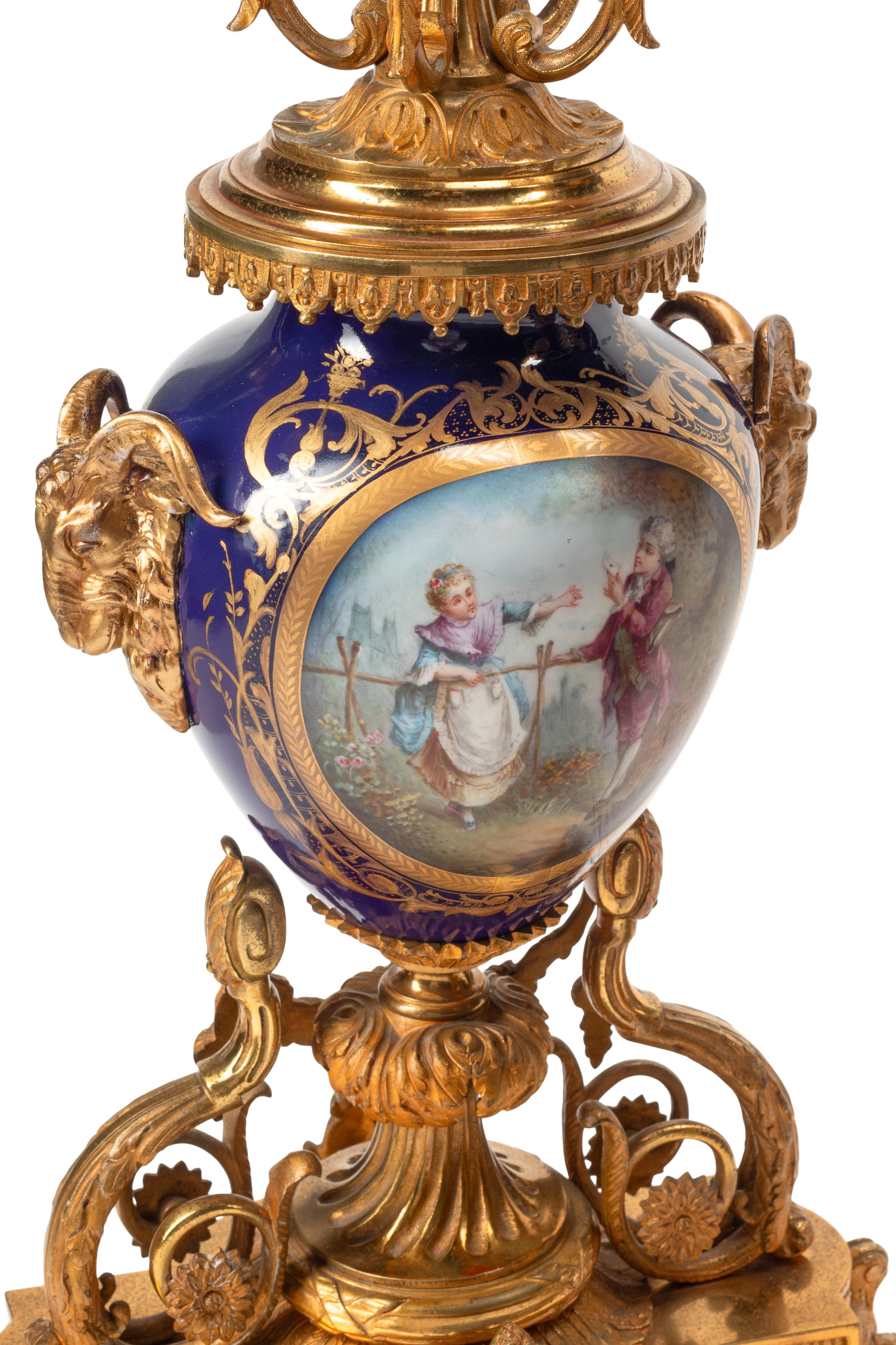 A Louis XVI Style Gilt Bronze and Sèvres Style Porcelain Clock Garniture