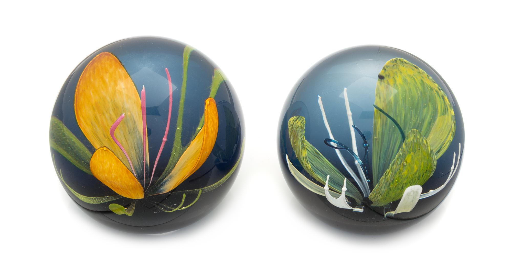 Caithness Glass, Scotland, two glass paperweights, each with flower decoration
