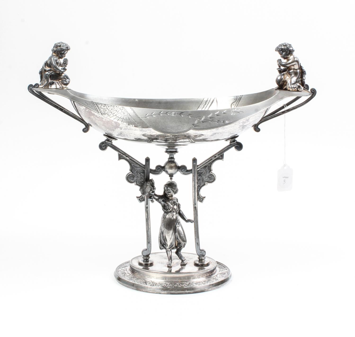 An Aesthetic Movement Silver-Plate Centerpiece Bowl Height 14 1/2 inches.