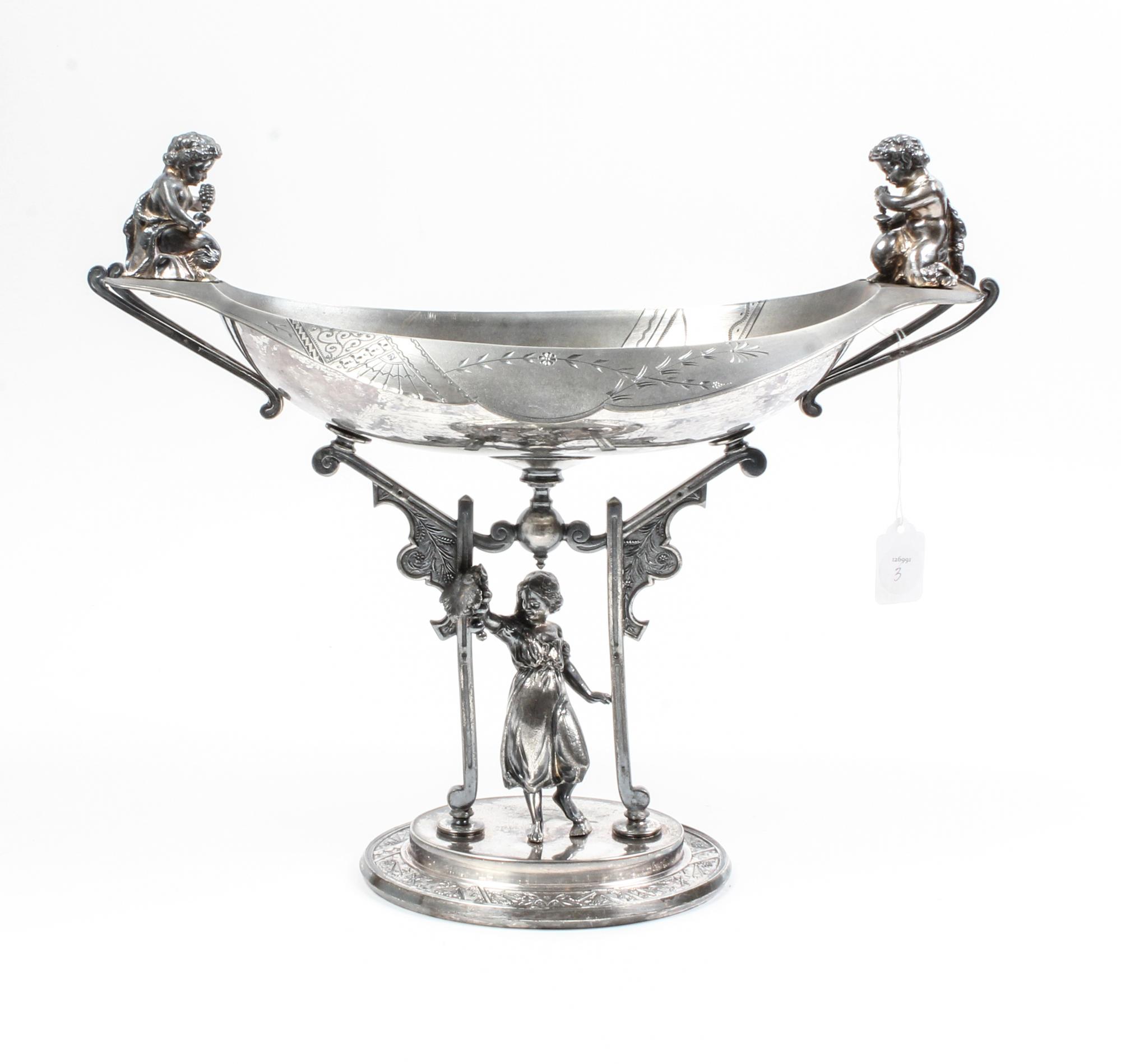 An Aesthetic Movement Silver-Plate Centerpiece Bowl Height 14 1/2 inches.