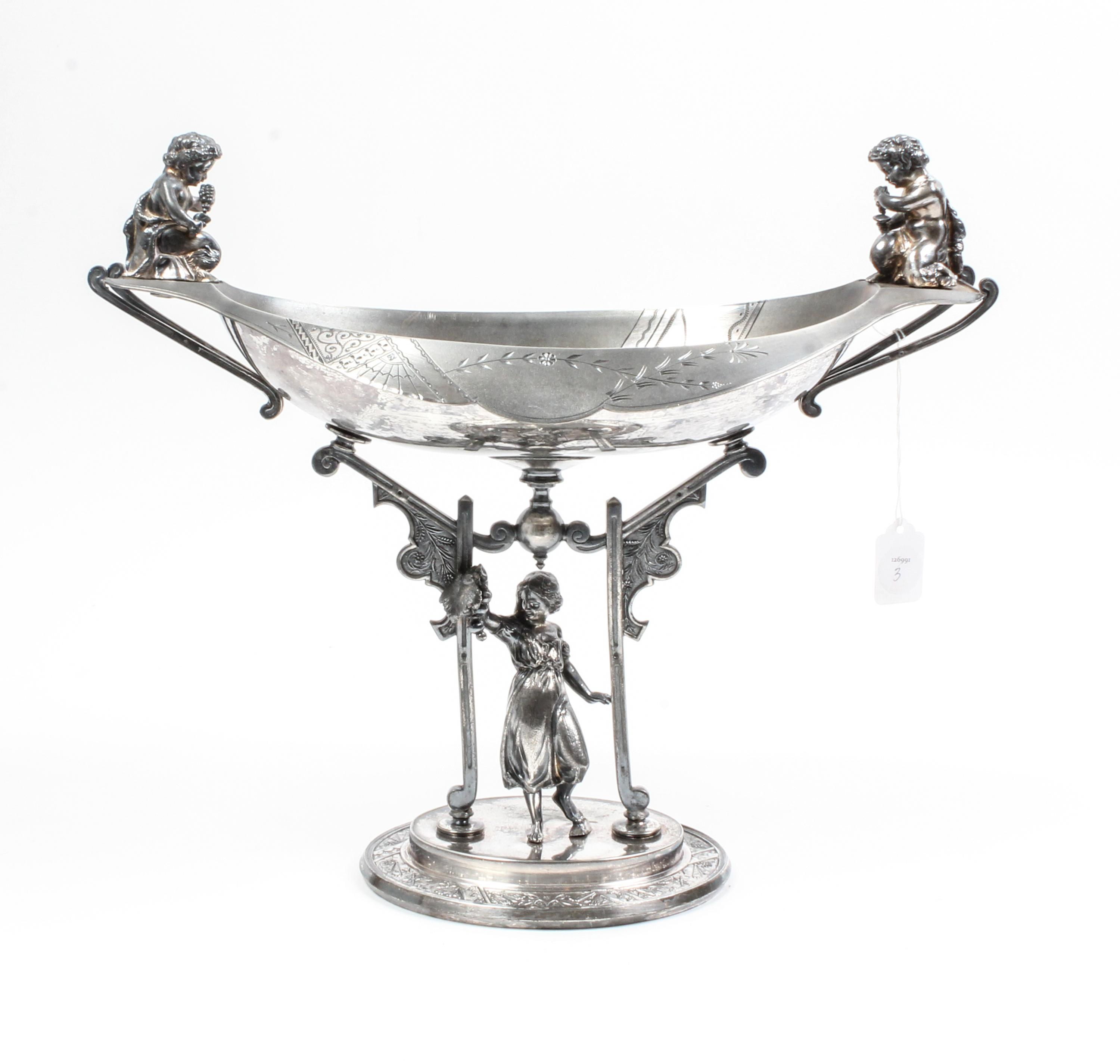 An Aesthetic Movement Silver-Plate Centerpiece Bowl Height 14 1/2 inches.