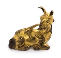 A Gilt Bronze Figure of a Recumbent Deer Height 2 7/8 inches. — MING DYNASTY (1368-1644)