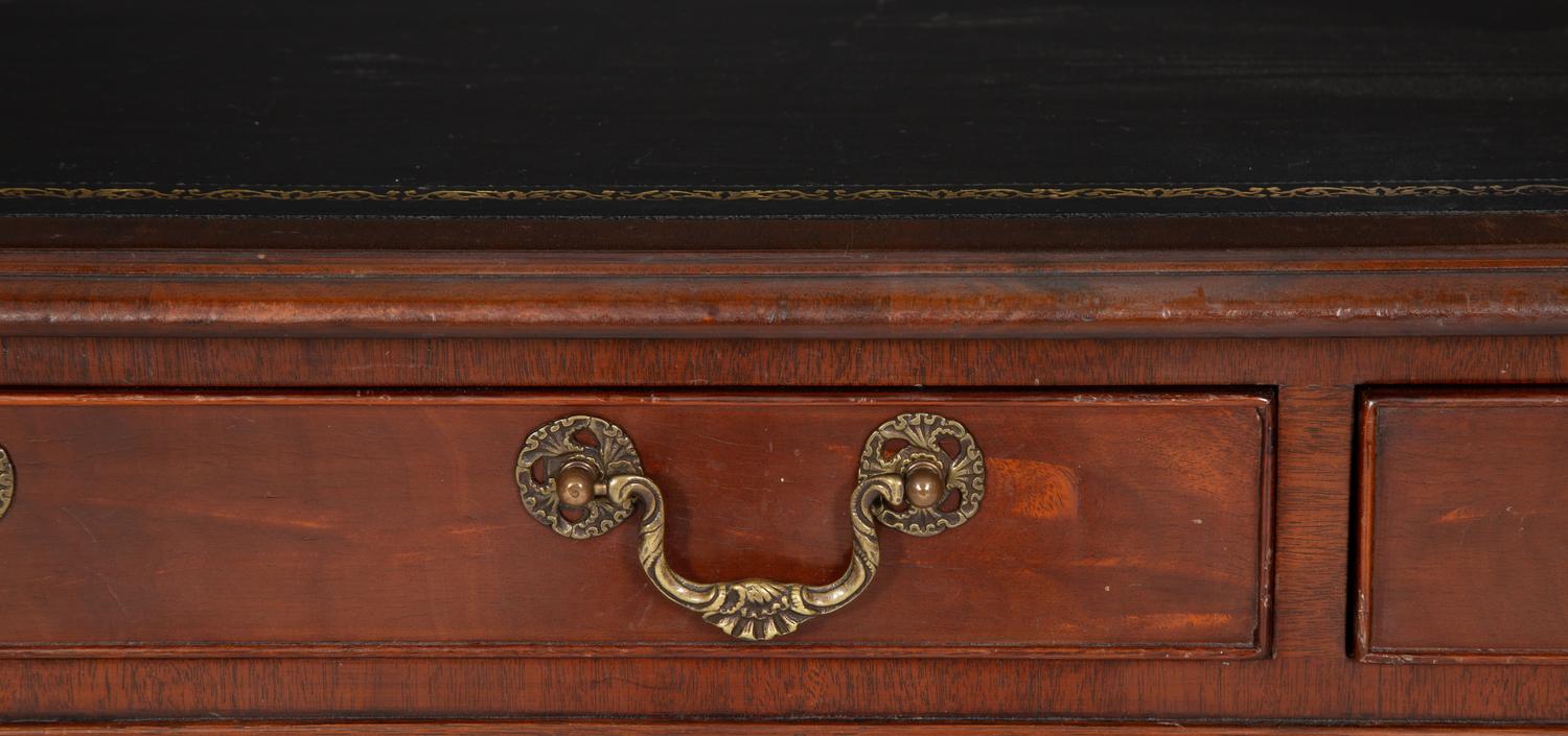 A Regency Style Parcel Gilt and Ebonized Mahogany Leather Top Console Table