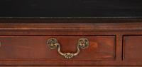 A Regency Style Parcel Gilt and Ebonized Mahogany Leather Top Console Table