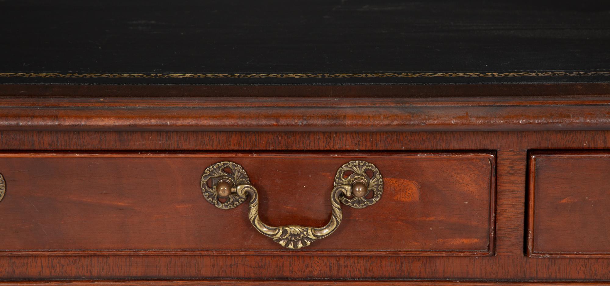 A Regency Style Parcel Gilt and Ebonized Mahogany Leather Top Console Table