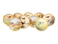 A Set of Eight Limoges Porcelain Fish and Game Plates