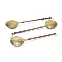 Group of three pierced and decorated brass and turned wood bed warmers 17th-19th century