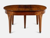 An Austrian Secessionist Inlaid Dining Suite, comprising a sideboard, a server, an extension dining table with five leaves, six side chairs and four armchairs