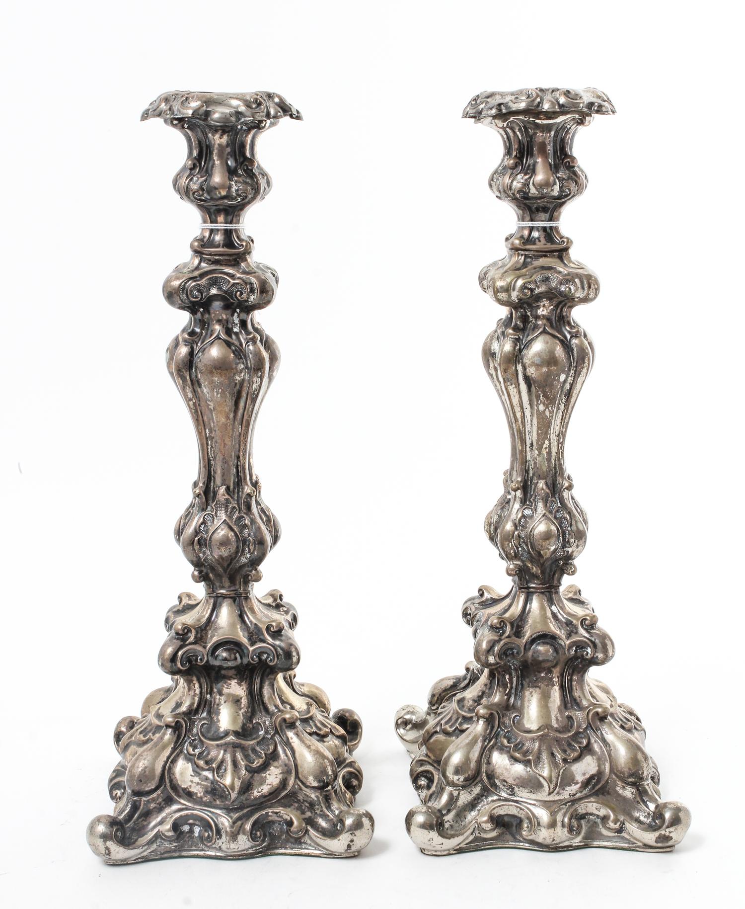 A Pair of Continental Silvered Metal Candlesticks, Late 19th/Early 20th Century, the undulating stems worked with volute and rocailled