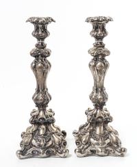 A Pair of Continental Silvered Metal Candlesticks, Late 19th/Early 20th Century, the undulating stems worked with volute and rocailled