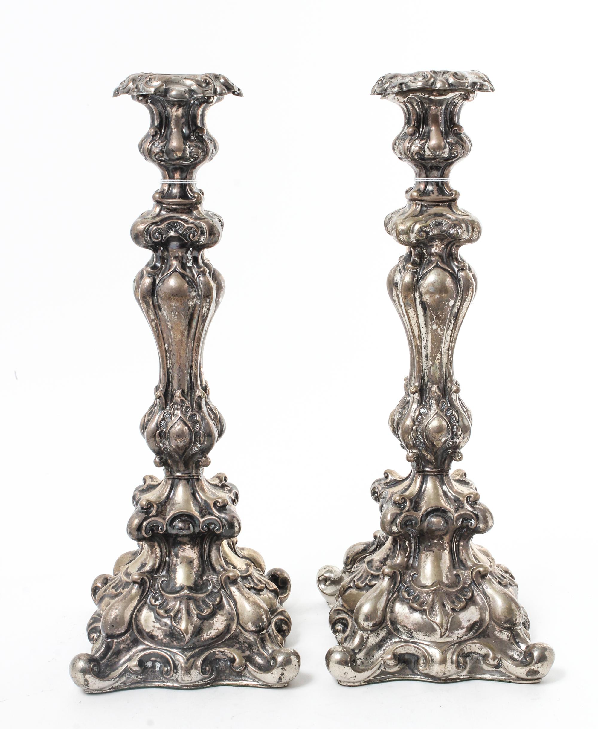 A Pair of Continental Silvered Metal Candlesticks, Late 19th/Early 20th Century, the undulating stems worked with volute and rocailled