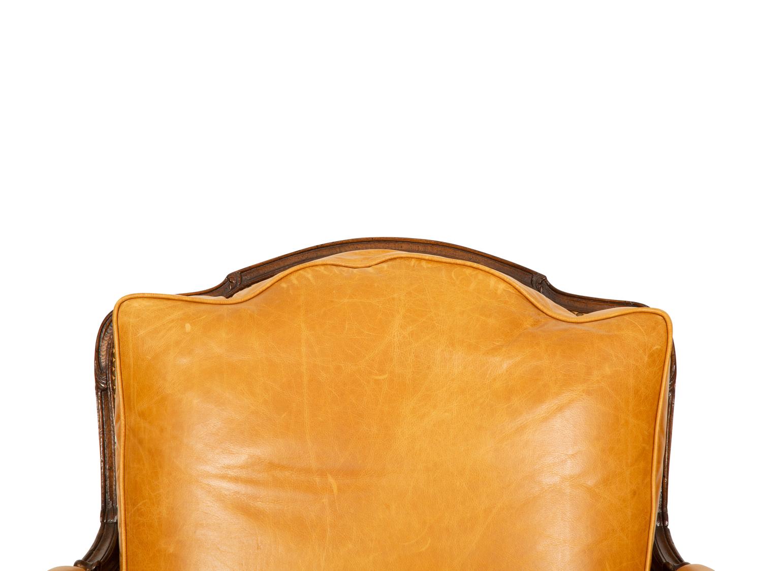 A Louis XVI Style Carved Mahogany Leather Upholstered Bergeré — 20th Century