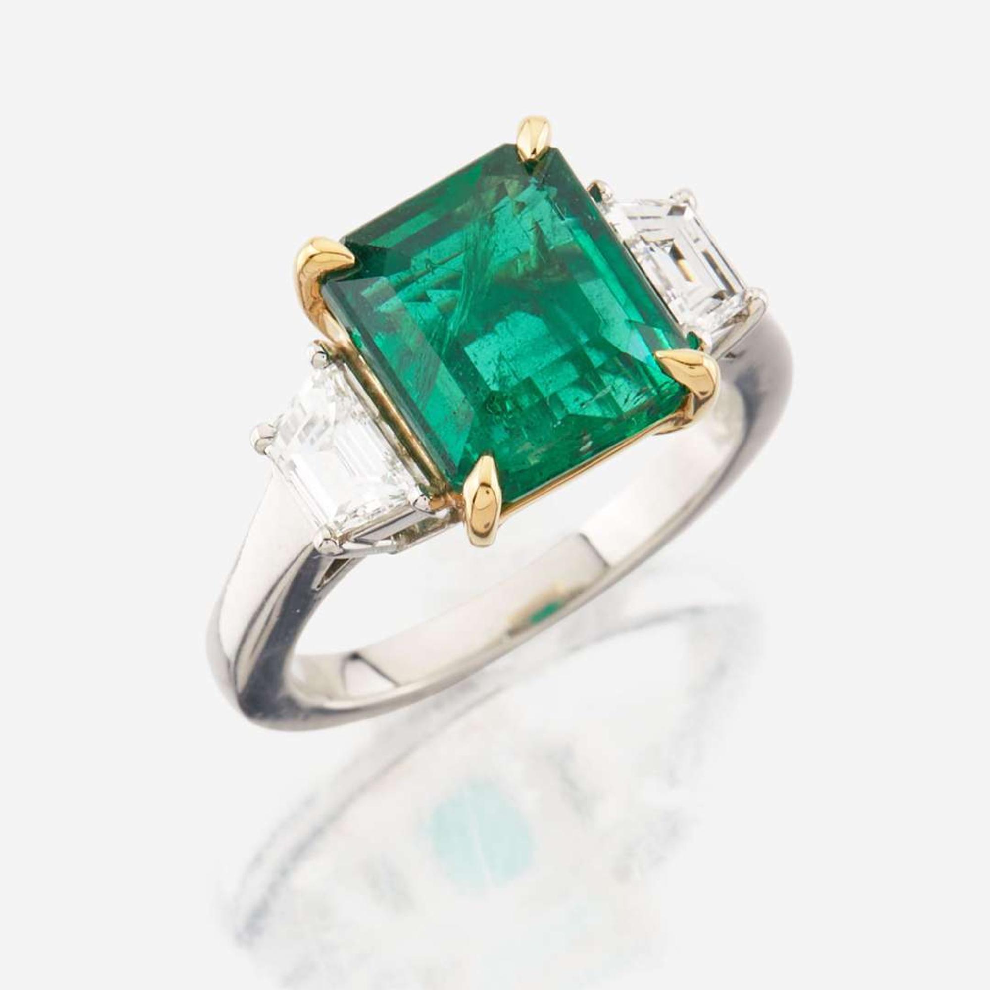 An emerald, diamond, and platinum ring