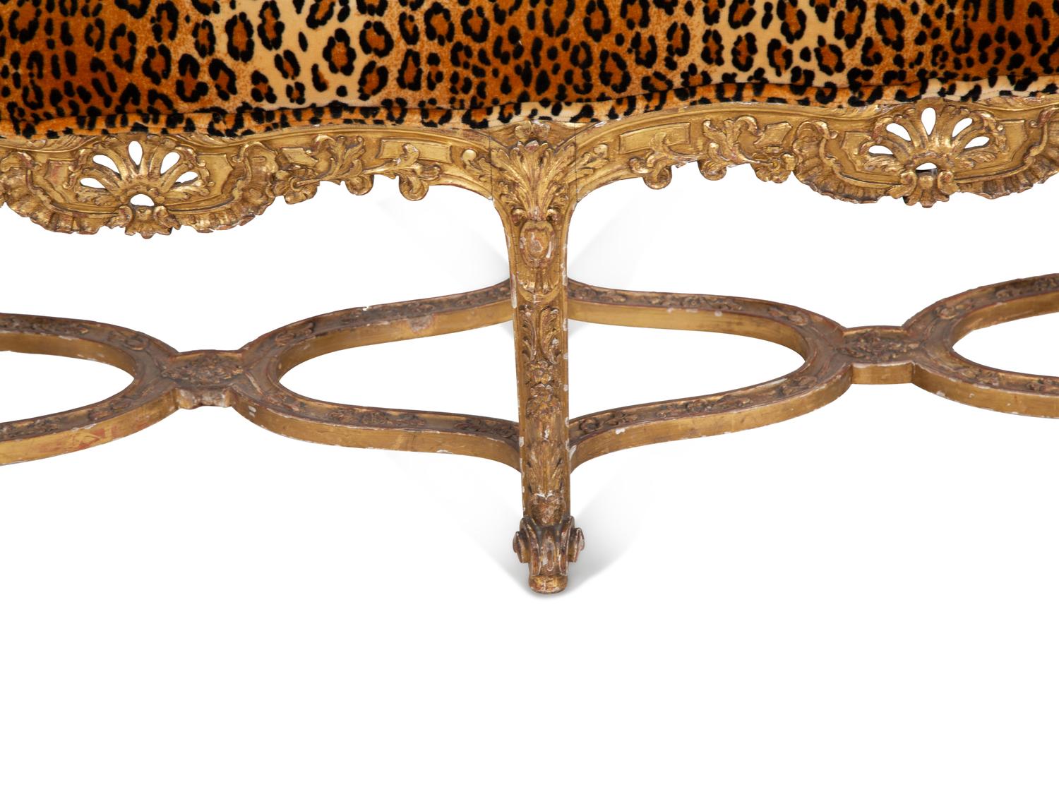 A Louis XV Style Giltwood Bench with Faux Leopard Upholstery